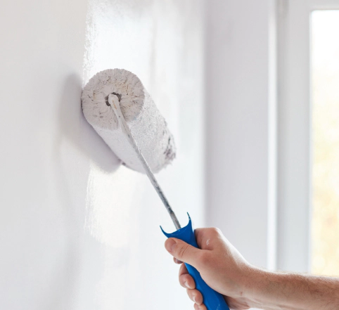 male hand painting wall with paint roller shelton ct